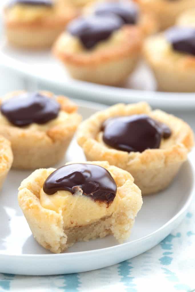 Close up shot of Boston Cream Pie Cookie Cups, and the front one has a bite taken out of it.