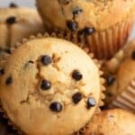 Titled image of keto chocolate chip muffins piled up in a white bowl.