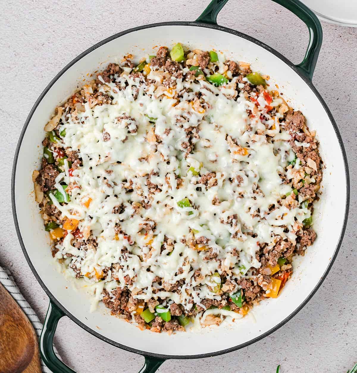 Top down image of Keto Stuffed Pepper Skillet in a large enameled pan with two handles.