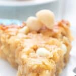 Titled image of a slice of Keto Macadamia Coconut Pie on a white plate.