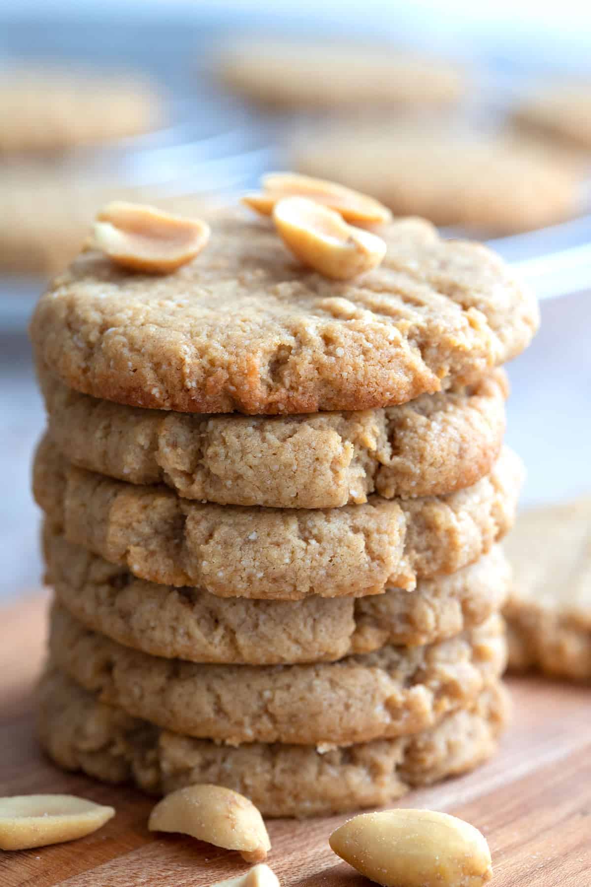 Close up shot of a stack of keto peanut butter cookies with peanuts on top.
