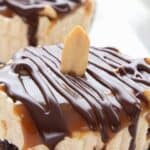 Close up titled image of Keto Snickers No Bake Cheesecakes on a white plate.