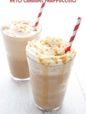 Titled image of two keto frappuccinos on a white table with striped red straws sticking out.