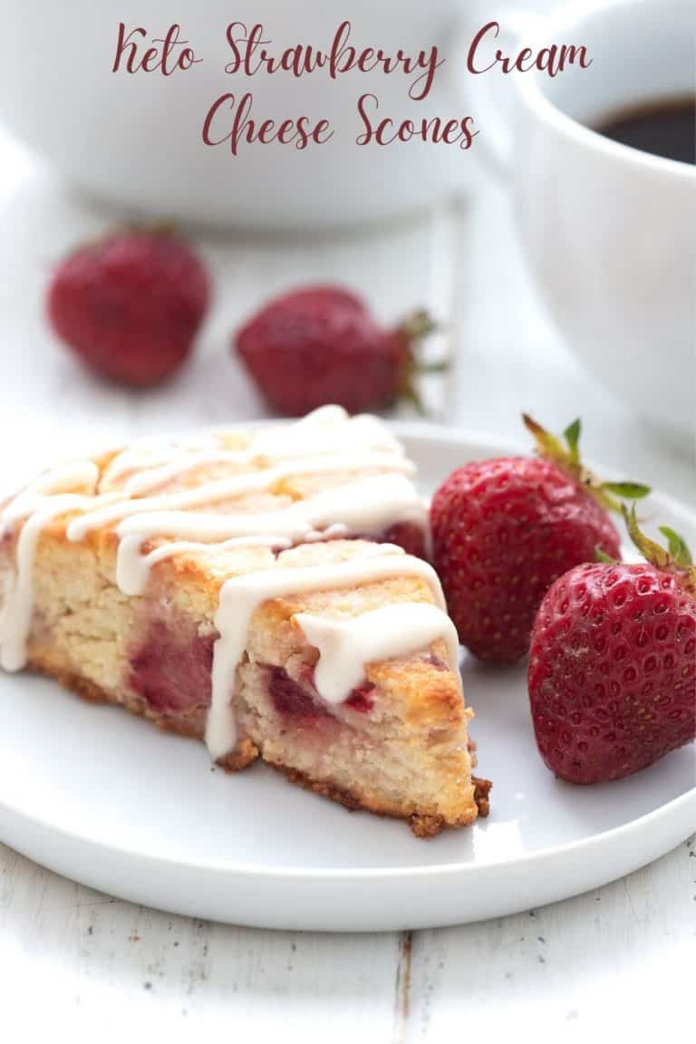 Titled image of a keto strawberry scone on a white plate, with fresh strawberries