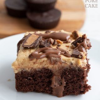 Titled image of keto chocolate peanut butter poke cake on a white plate, with keto peanut butter cups in the background.