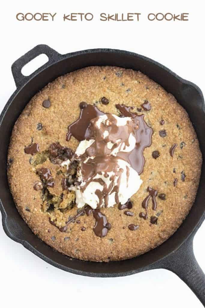 Top down image of a keto skillet cookie topped with ice cream and chocolate sauce.