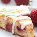 Titled image of a keto strawberry scone on a white plate with a strawberry.