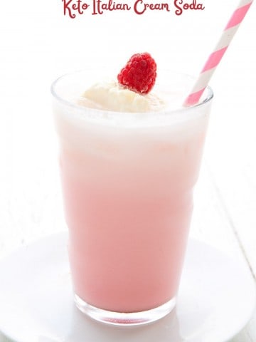 Titled image of a glass of sugar free Italian Cream Soda with a pink striped straw.