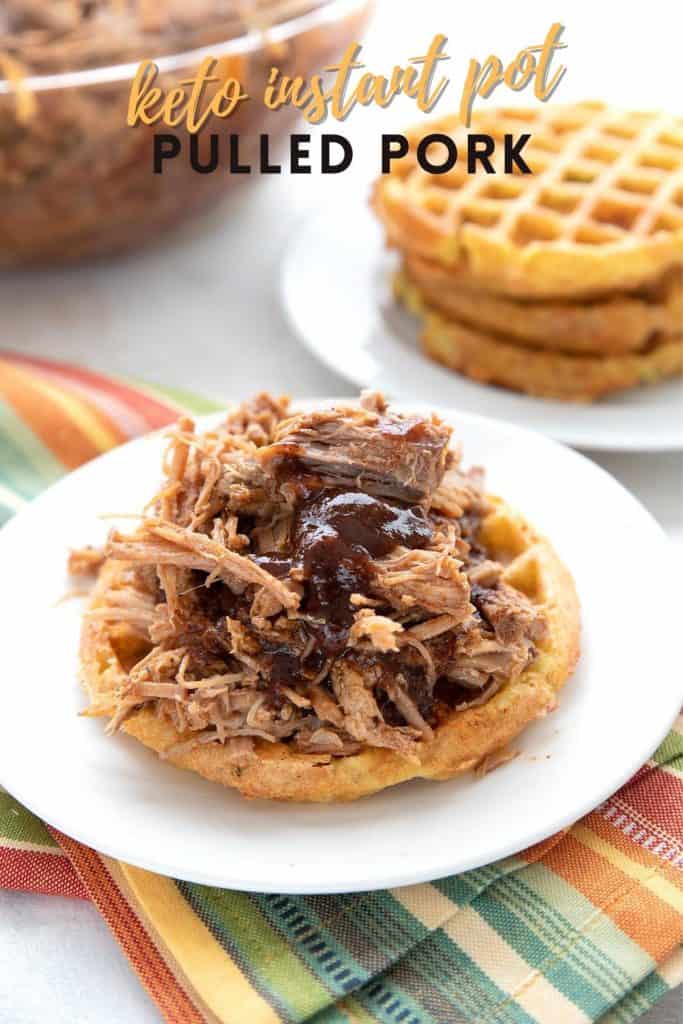 Titled image of keto pulled pork served on a waffle bun, on a white plate.