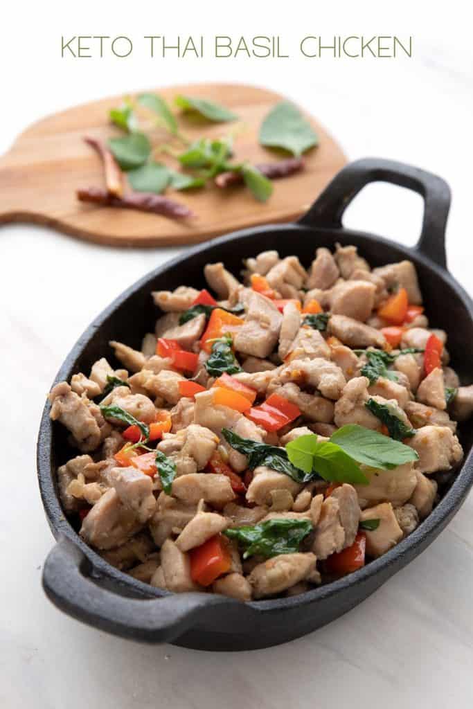 Titled image of Keto Thai Basil Chicken in a cast iron pan.