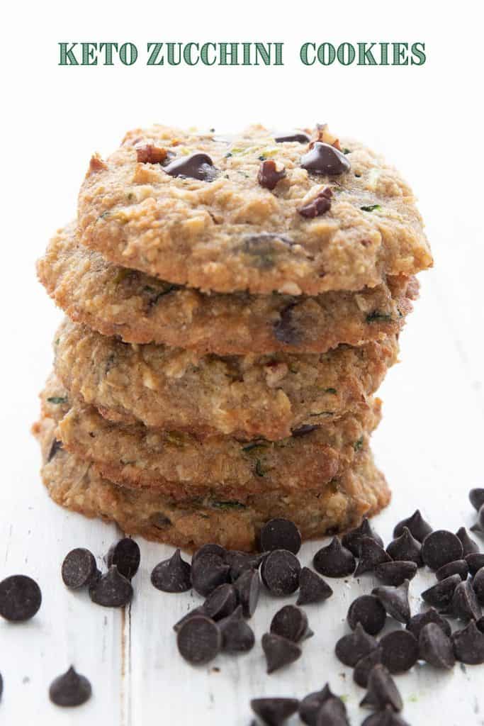 Titled image of keto zucchini cookies in a stack with chocolate chips around the base.