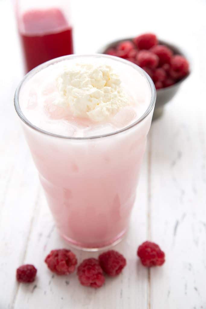 Close up shot showing whipped cream on top of a glass of sugar free Italian cream soda