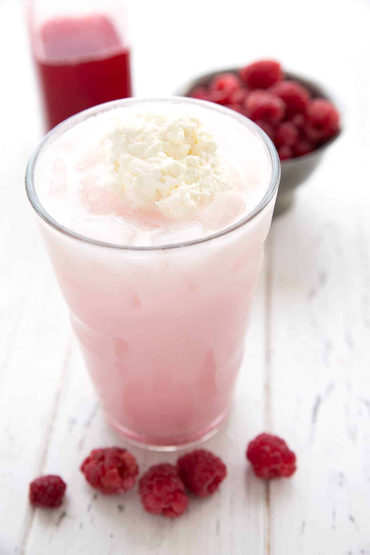 Close up shot showing whipped cream on top of a glass of sugar free Italian cream soda