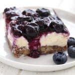 A slice of sugar free blueberry jamboree on a white plate.