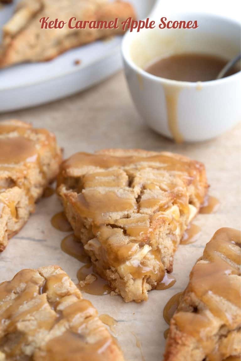 Titled image of Keto Caramel Apple Scones on brown parchment paper with a bowl of sugar free caramel sauce.