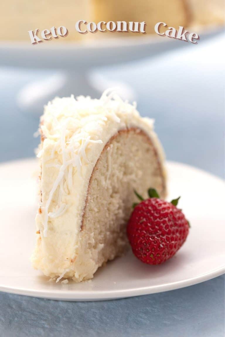 Titled image of a slice of keto coconut cake on a white plate with a strawberry.