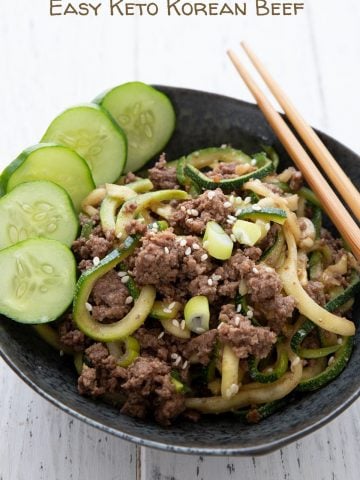 Titled image of a bowl of keto Korean beef with zucchini noodles and chopsticks on the side.