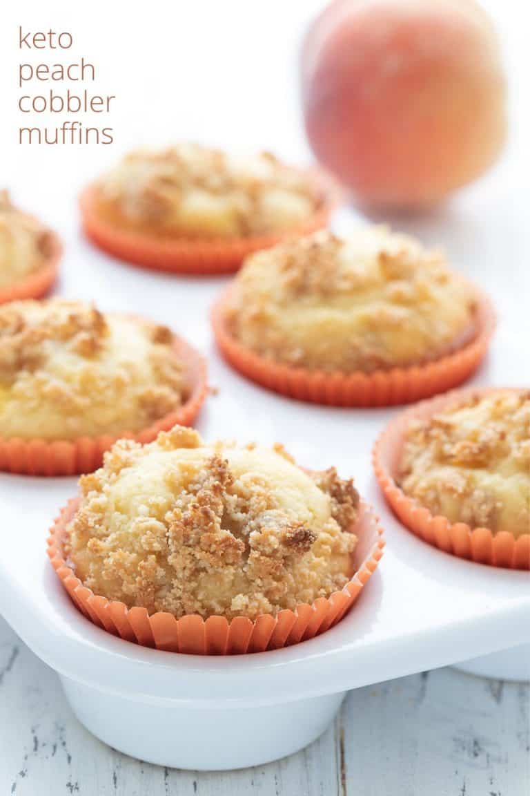 Titled image of keto peach muffins in a white ceramic muffin pan with a peach in the background.