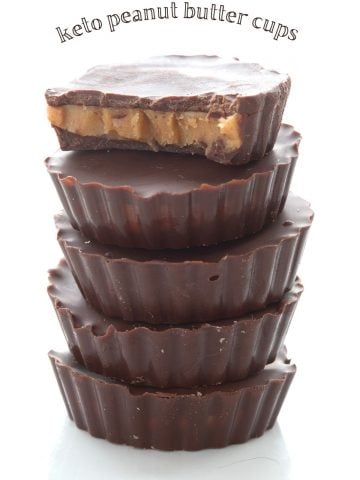 Titled image of a stack of keto peanut butter cups, and the top one has a bite taken out of it.
