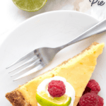 Titled Pinteres image of a slice of keto key lime pie on a white plate with raspberries and a fork.