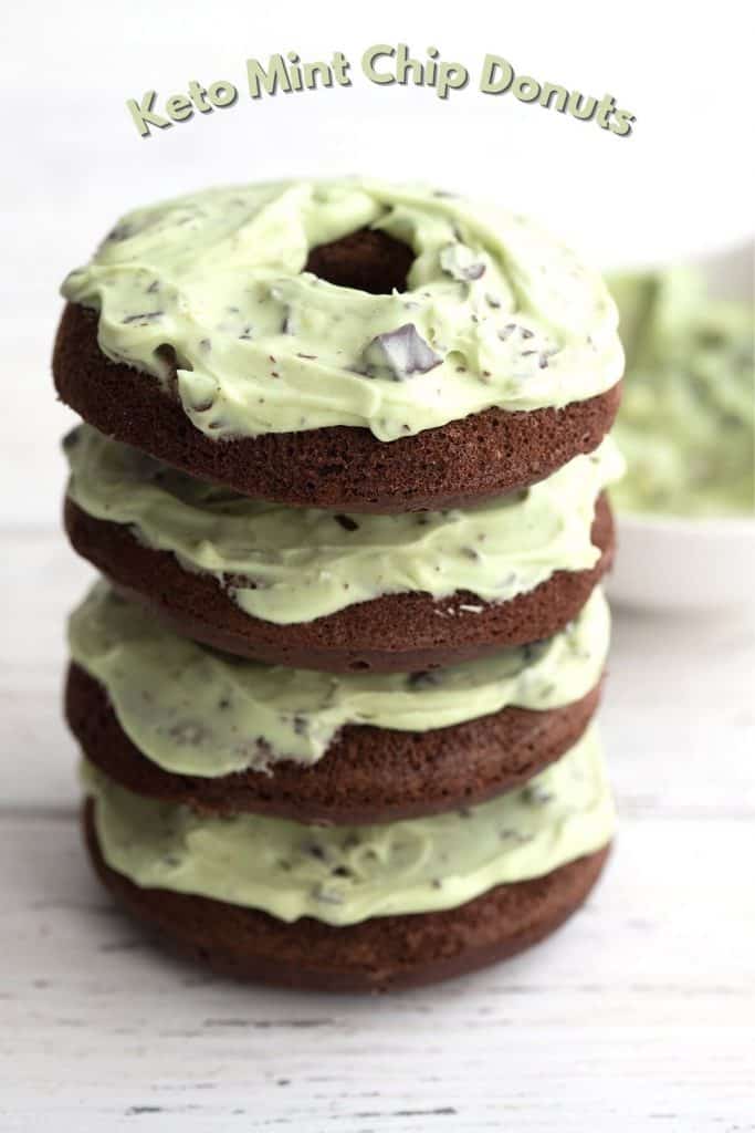 Titled image of a stack of keto chocolate donuts with mint chip frosting on a white table.