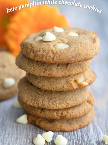 Titled image of keto pumpkin cookies with white chocolate chips in a stack.