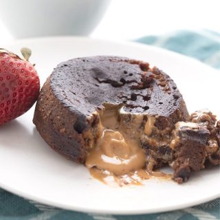 Titled image of keto chocolate peanut butter lava cake broken open to show the gooey inside.