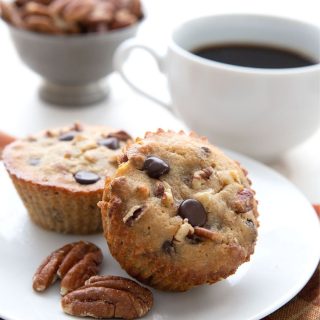 Titled image of keto pecan pie muffins on a white plate with a cup of coffee in behind.