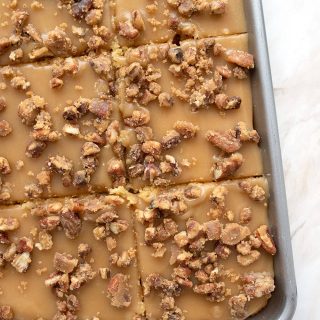 Top down photo of keto praline sheet cake in the pan, cut into slices.