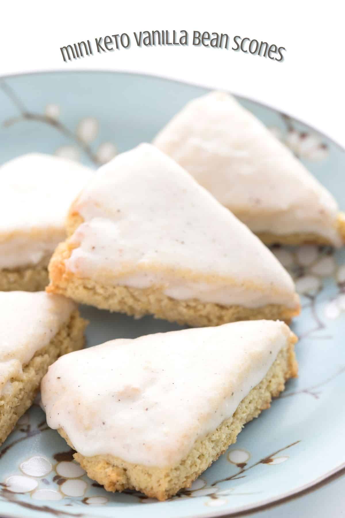 Titled image of a pile of mini keto vanilla bean scones on a blue patterned plate.