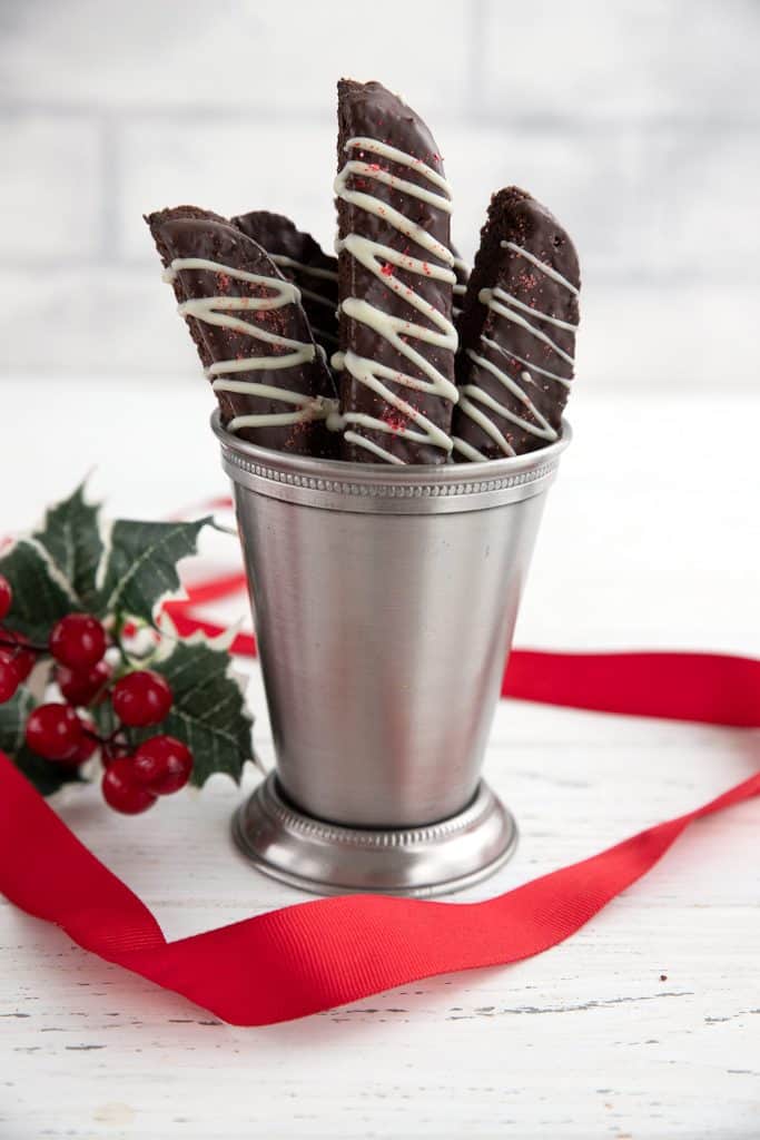 A metal cup filled with keto chocolate peppermint biscotti.