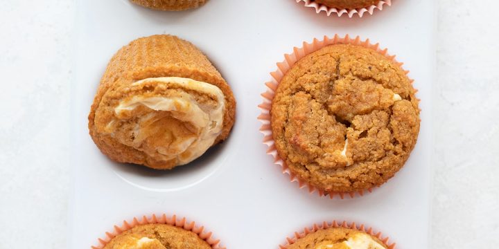 Top down image of a white muffin pan filled with Keto Pumpkin Muffins.