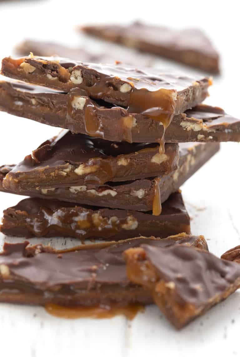 A stack of keto pecan turtle bark with chewy sugar free caramel oozing out.