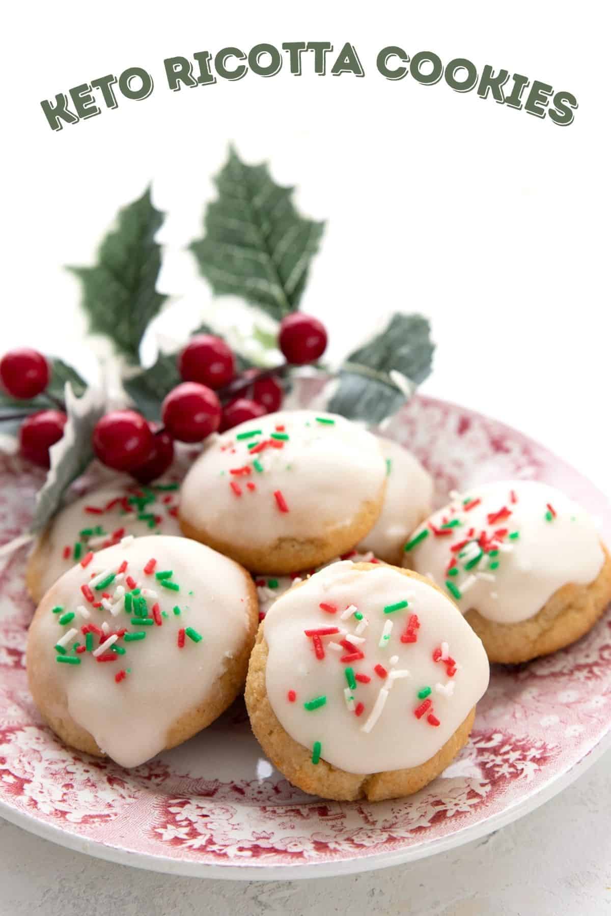 Titled image: Keto Ricotta Cookies on a red patterned plate with holly in the background.