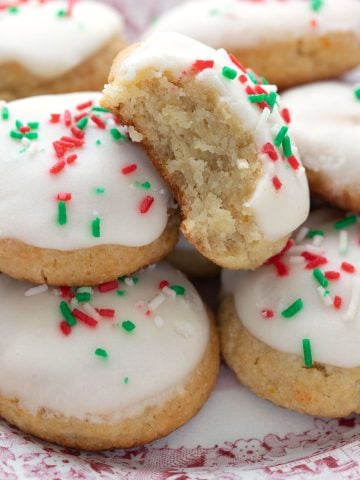 Close up shot of keto Italian ricotta cookies, one with a bite taken out of it.