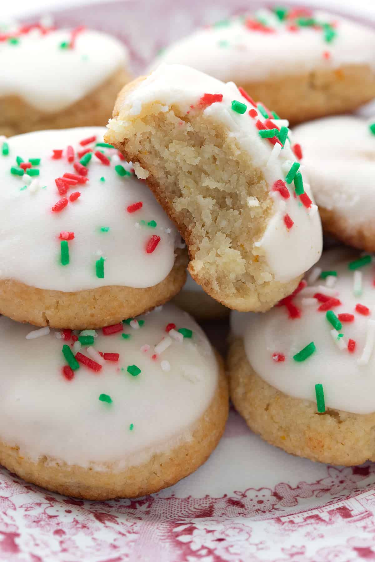 Close up shot of keto Italian ricotta cookies, one with a bite taken out of it.