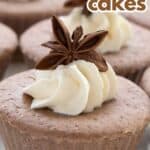 Titled image of individual Keto Gingerbread Cheesecakes on a white cake tray, with whipped cream and star anise on top.