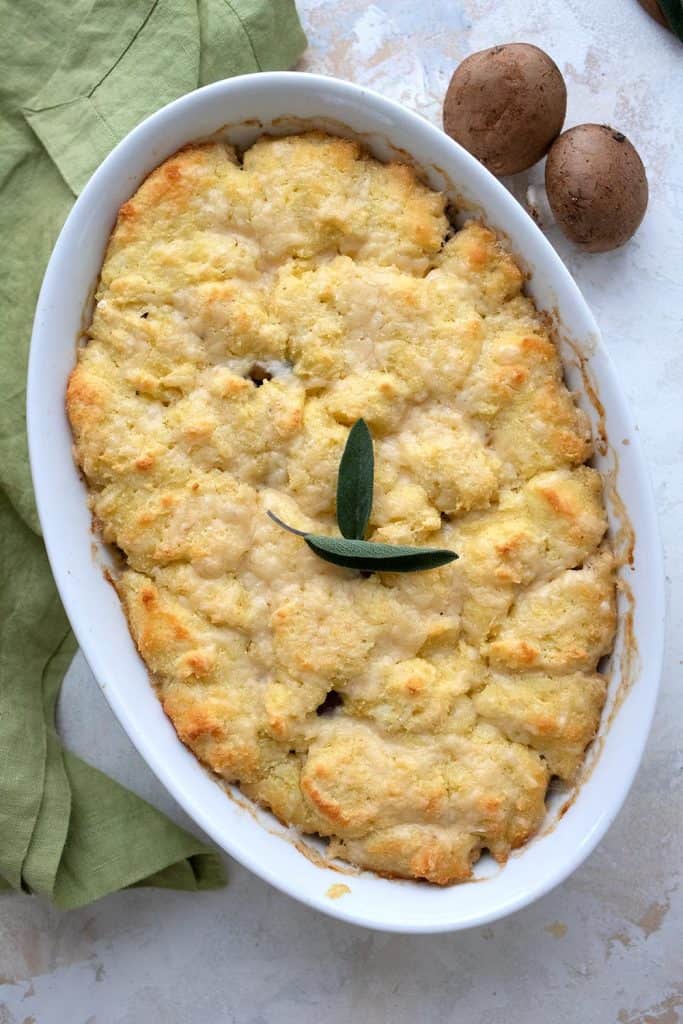 Top down image of keto chicken pot pie in a baking dish with a green napkin.