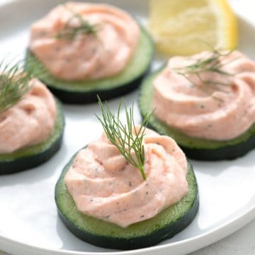 Close up shot of smoked salmon mousse cucumber appetizers.