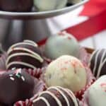 Titled image of keto peppermint truffles on a wooden tray on a white table.