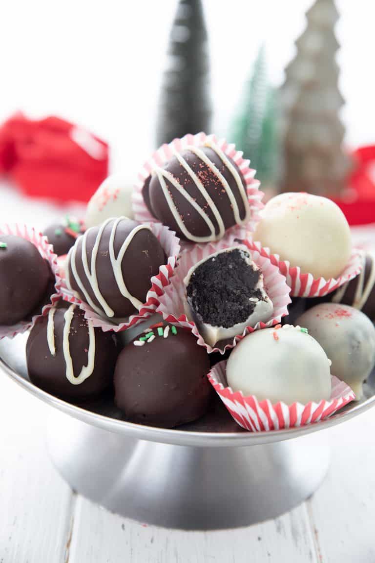 Keto peppermint oreo truffles piled up on a metal cake stand.