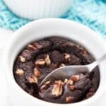 Titled Pinterest image of a keto mug brownie with a spoon digging into it.