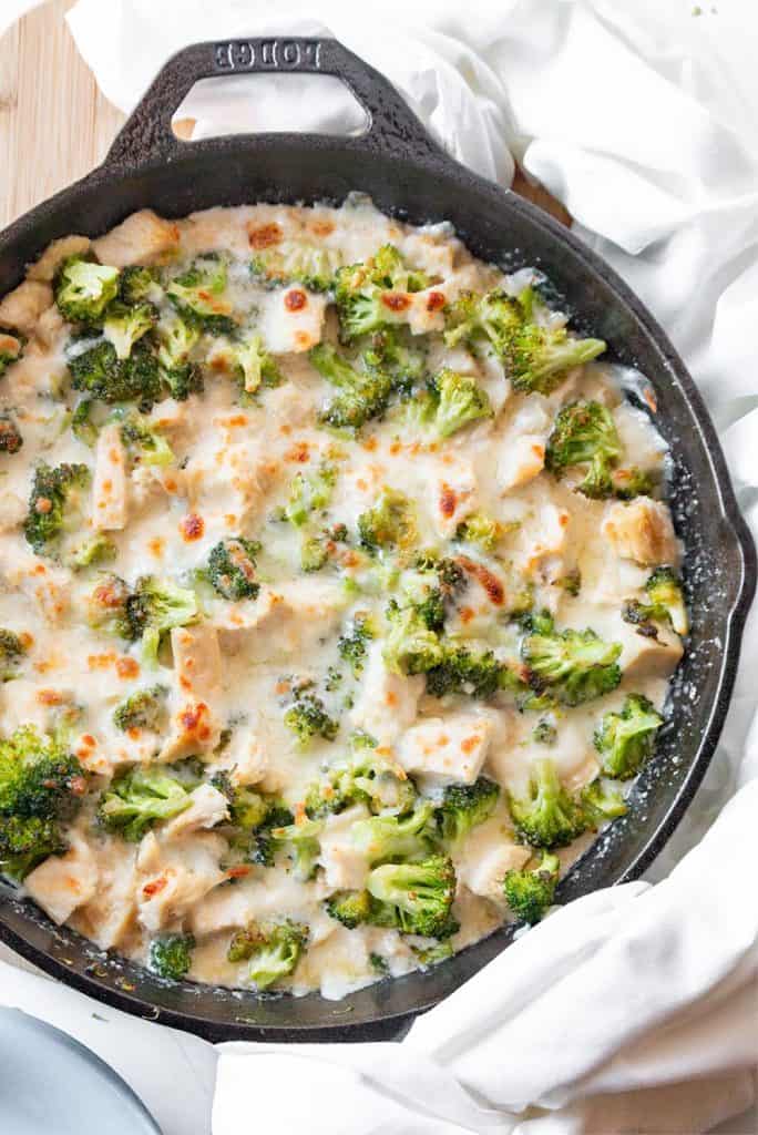 Top down image of keto chicken broccoli casserole in a cast iron skillet.