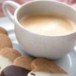 Heart-shaped Espresso Shortbread arranged on a white plate with a cup of coffee.