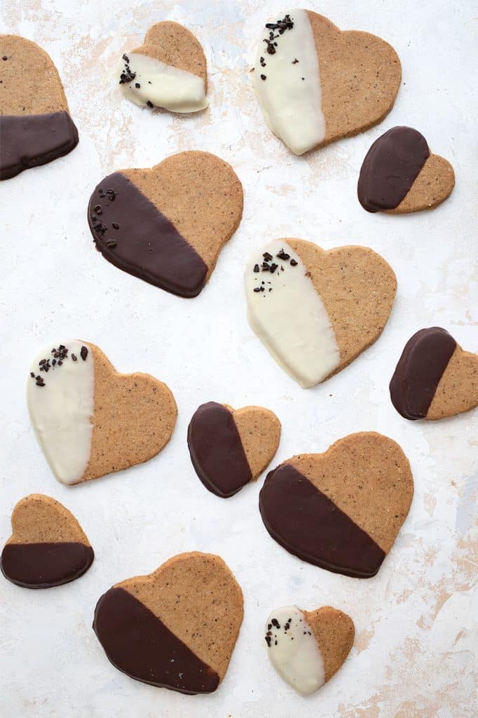 Top down image of chocolate dipped keto shortbread cookies on a white table.
