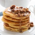 A stack of almond flour keto pancakes topped with sugar-free pecan praline syrup.