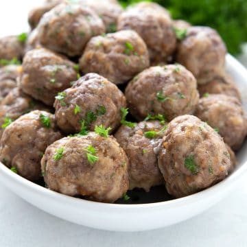 A white oval dish filled with keto meatballs for meal prep.