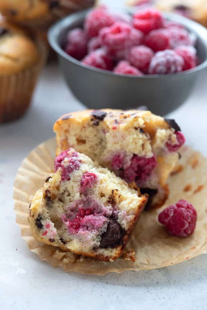 A keto raspberry muffin broken open to show the inside.