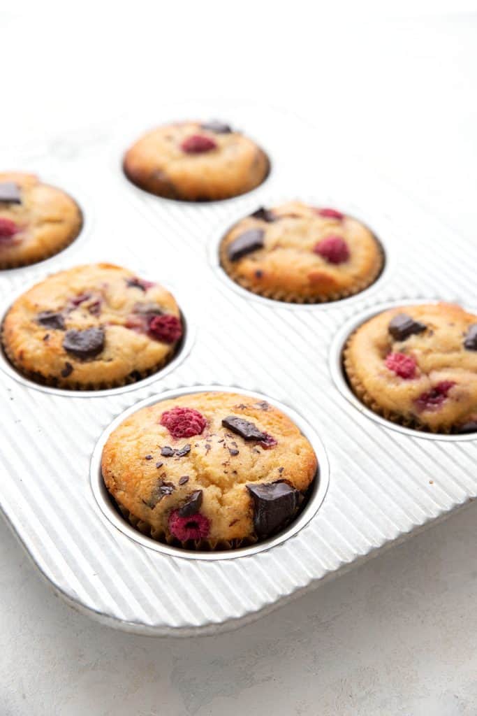Keto raspberry chocolate chunk muffins in a muffin pan.