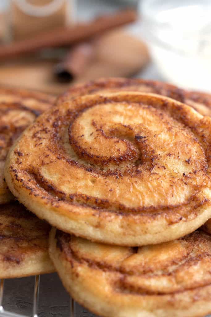 Close up shot of cinnamon rolls pancakes to show the cinnamon swirl.